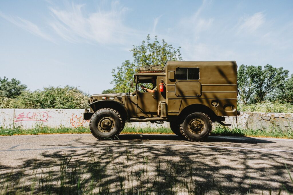 Vintage olive drab military truck parked on a sunny roadside