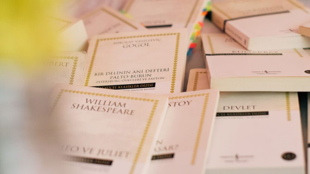 A collection of classic literature books laid out on a table.