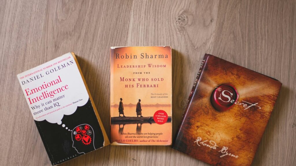 three books sitting on top of a wooden table